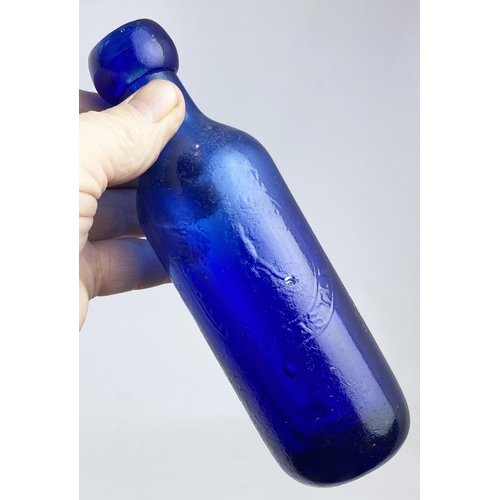 574 - NEWCASTLE BOTTLE. 6.5ins. Cobalt blue, faint embossing, R. EMMERSON , penny farthing pict t.m. Surfa... 