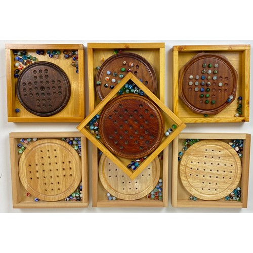 497 - SOLITAIRE GROUP. Variety of wooden boards with mix of marbles. (7)