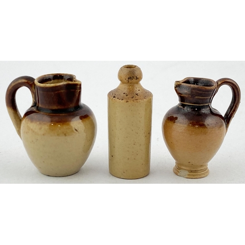 127 - MINIATURE DOULTON (UNMARKED) POTTERY GROUP. Tallest (g.b) 27mms tall. Two handled jugs, (foot chip) ... 