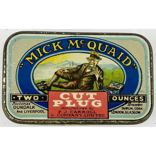 50 - MICK MC QUAID TOBACCO TIN. 2 x 3.25ins. Great pictorial to front of man laid on grass. Surface wear.