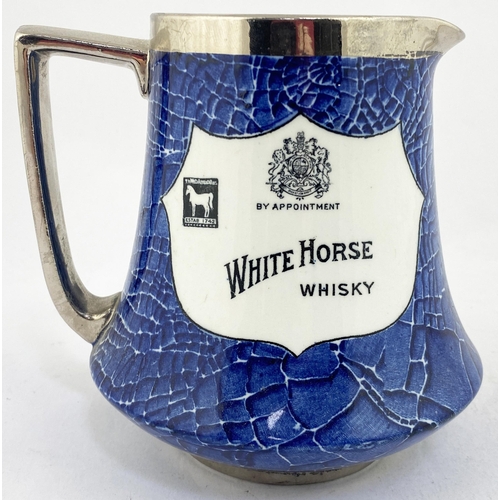 56 - WHITE HORSE WHISKY PUB JUG. 5.4ins tall. Classic blue & white jug with two different shield shaped d... 