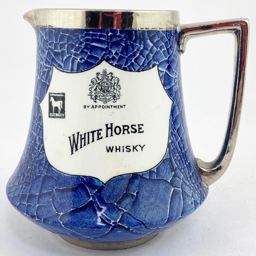 56 - WHITE HORSE WHISKY PUB JUG. 5.4ins tall. Classic blue & white jug with two different shield shaped d... 