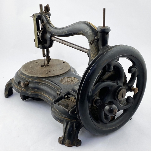 100 - JONES HAND MACHINE CAST IRON SEWING MACHINE. 10.25ins tall. Superb heavy Victorian cast iron machine... 