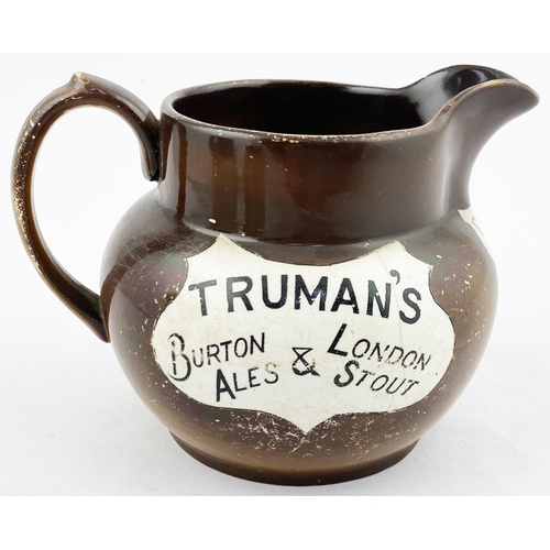 109 - TRUMANS BURTON ALES & LONDON STOUT WATER JUG. 4.3ins tall. Brown body (worn) Transferred both sides ... 