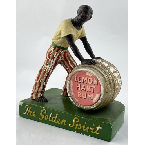 116 - LEMON HART RUM ADVERTISING STATUETTE. 10.7install. Painted plaster cast of black gent rolling a barr... 