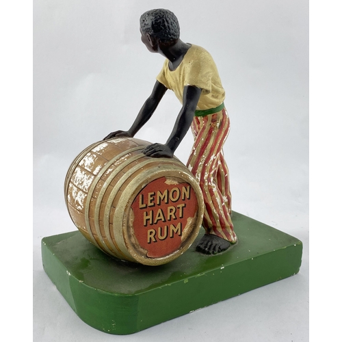 116 - LEMON HART RUM ADVERTISING STATUETTE. 10.7install. Painted plaster cast of black gent rolling a barr... 