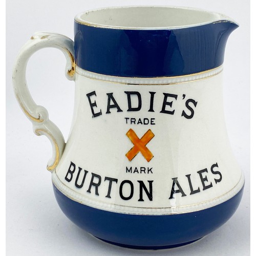 16 - EADIES BURTON ALES WATER JUG. 5.3ins tall. Dark blue top & bottom, black transfer each side with ora... 