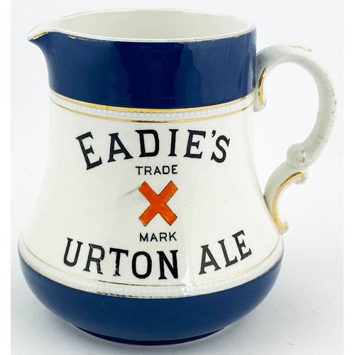 16 - EADIES BURTON ALES WATER JUG. 5.3ins tall. Dark blue top & bottom, black transfer each side with ora... 