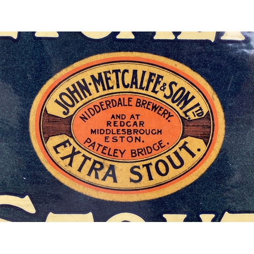 21 - YORKSHIRE & NORTH EASTMETCALFS STOUT SHOWCARD. 9.5 x 7.1ins. Shiny coated car ad with central oval s... 