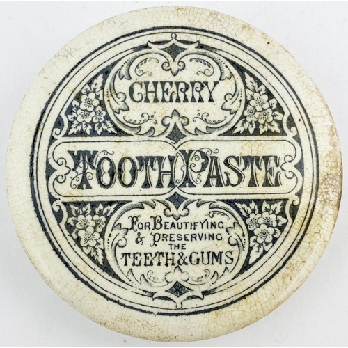 49 - CHERRY TOOTH PASTE POT LID. 4ins diam. Black transfer with flowers to four corners. Some crazing & s... 