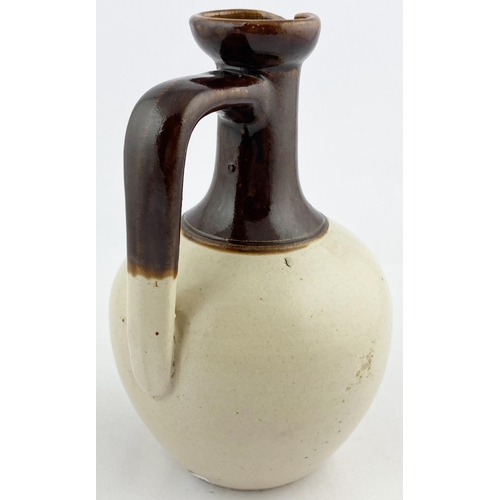 55 - DUFFTOWN WHISKY JUG. WG p49, B113. 8ins tall. Dark brown long neck, brown transfer, rear handle. GLE... 