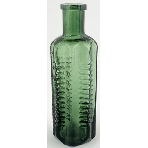 85 - STAR POISON BOTTLE. DP p58. 4.5ins tall, green glass, vertically embossing between ribbed panels, ba... 