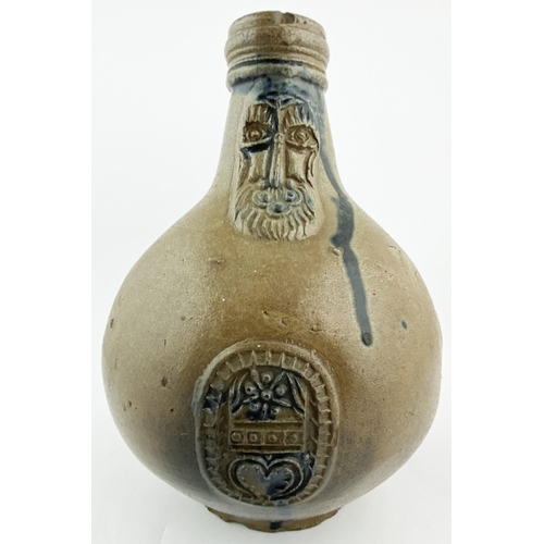 122 - BELLARMINE JUG. 8ins tall. Dark salt glaze finish, bulbous body. Familiar bearded face sprig below n... 