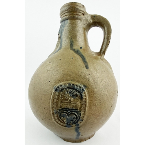 122 - BELLARMINE JUG. 8ins tall. Dark salt glaze finish, bulbous body. Familiar bearded face sprig below n... 