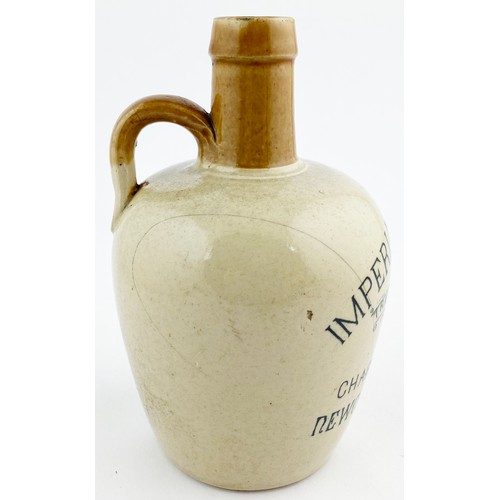 54 - NEWCASTLE ON TYNE WHISKY JUG. 7.5ins tall. Tan neck, black transfer, rear handle. IMPERIAL WHISKY/ C... 