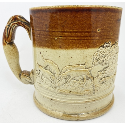 63 - GREYHOUND HANDLED MUG. 5.4ins tall, t.t. Five applied hunting scene sprigs. Tooled base, minor damag... 