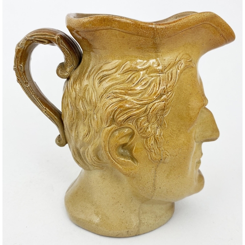 69 - UNKNOWN CHARACTER HEAD JUG. 6.1ins tall. Mid golden brown salt glaze, very well modelled head, trico... 