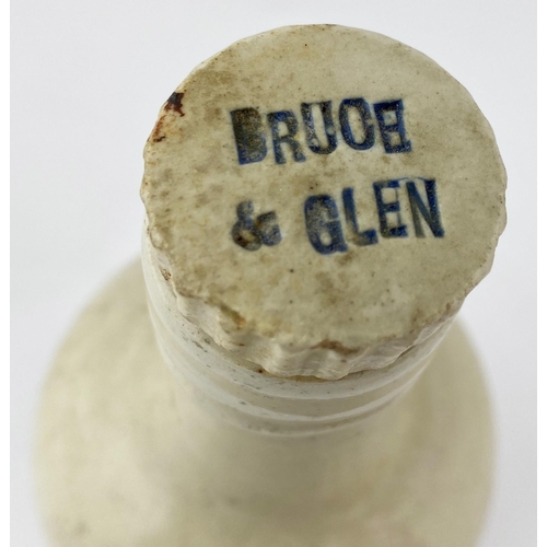 79 - DUNFERMLINE BRUCE & GLENN AMMONIA BOTTLE. DP p129. 11ins tall, off white/ cream upper body, lower un... 