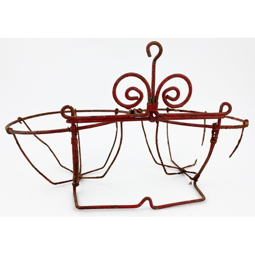 88 - FIRE GRENADE WIRE RACK HOLDER. 5.6ins tall, 10ins wide. Bent wire wall mounted support to hold two g... 