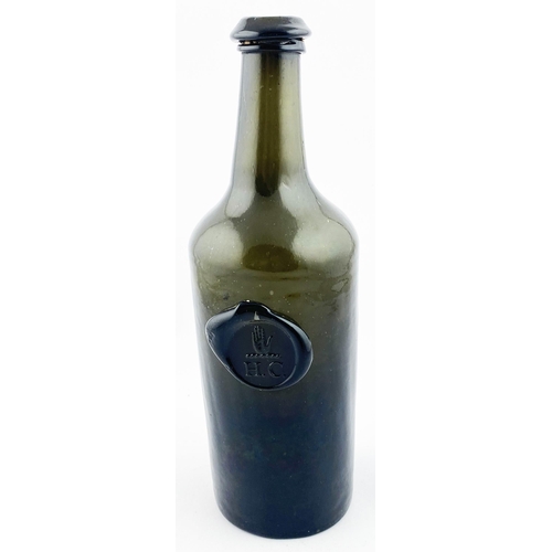 211 - ENGLISH SPLIT SIZE SEALED CYLINDER WINE BOTTLE. 10.4ins tall. Deep olive green/ black glass, rounded... 