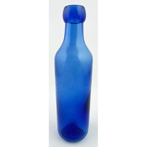 21 - NEWCASTLE BLUE CYLINDER BOTTLE. 8.5ins tall. Bright cobalt blue glass upright 10oz cylinder, blob to... 