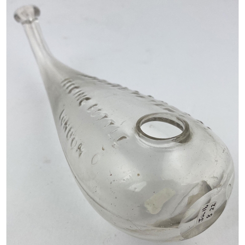 191 - KNOTT PATENT BABY FEEDER. 7.2ins long. Clear glass hand blown form with upturned neck, ground base p... 