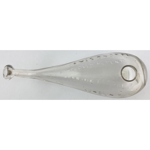 191 - KNOTT PATENT BABY FEEDER. 7.2ins long. Clear glass hand blown form with upturned neck, ground base p... 