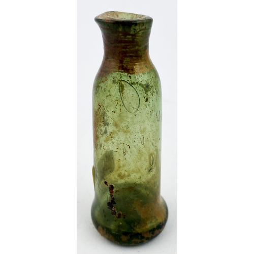 184 - FREE BLOWN APOTHECARY PHIAL. 2.8ins tall, very crude 17th c. greeny tinged glass cylinder, gradually... 