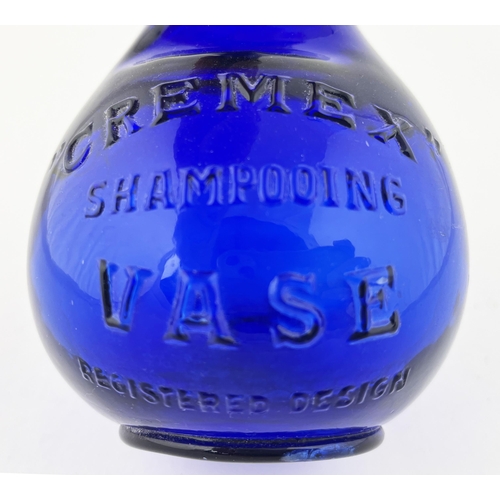 327 - CREMEX SHAMPOOING VASE. 7.5ins tall. Cobalt blue glass, embossed to front, ribbed back. Slight ding ... 