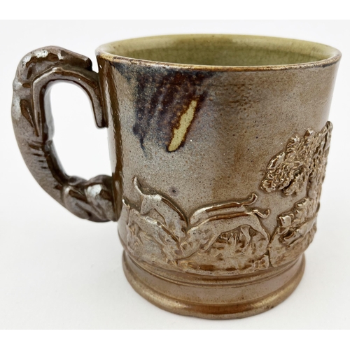 661 - SALT GLAZE HUNTING SCENE MUG. 4.25ins tall. Sprigged with grey hound handle. Base rim chips.