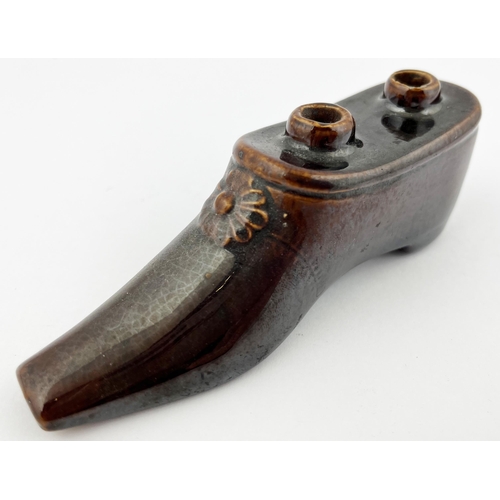 662 - SHOE INKWELL. 1.75ins tall. Treacle glaze shoe shaped inkwell, with pen holes to top. Minute nibbles... 