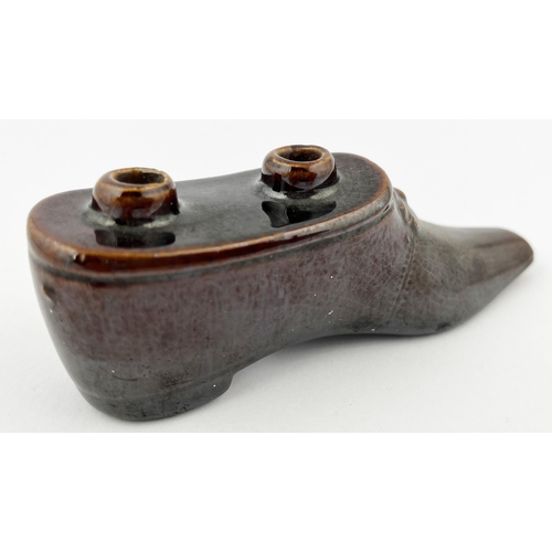 662 - SHOE INKWELL. 1.75ins tall. Treacle glaze shoe shaped inkwell, with pen holes to top. Minute nibbles... 