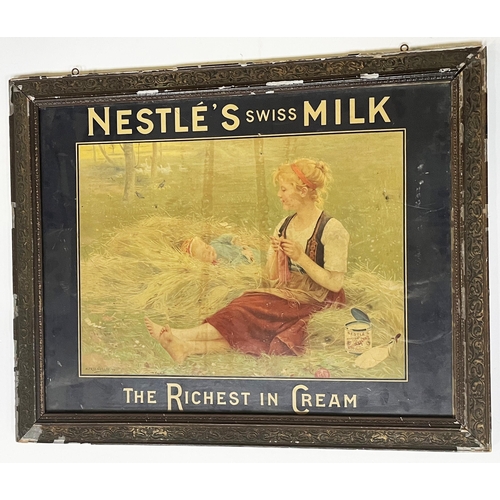 36 - NESTLES MILK FRAMED SHOWCARD. 29.5 x 24ins. NESTLES SWISS MILK. Lady watching over baby sat on a bed... 