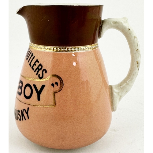 204 - MITCHELL & BUTLERS DUMBARTON OLD IRISH WHISKY WATER JUG. 4.5ins tall. Rear handle, pink body, black ... 