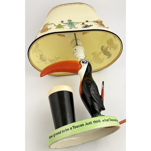 285 - GUINNESS TOUCAN LAMP & SHADE. 16.6ins tall. Original multi coloured hand painted toucan, glass in fr... 