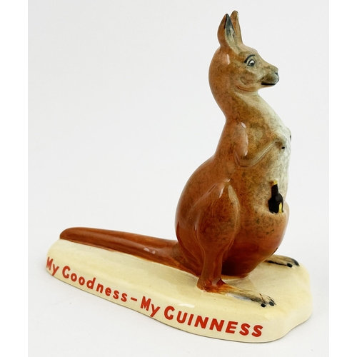 294 - KANGAROO PROMOTIONAL MINIATURE FIGURE. 4ins tall. Bottle of Guinness in pouch. Red Carltonware base ... 