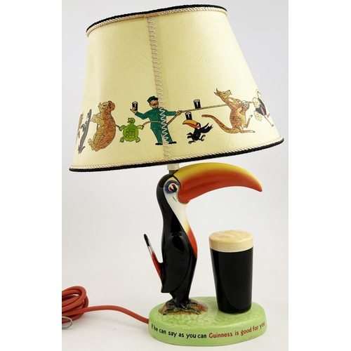 285 - GUINNESS TOUCAN LAMP & SHADE. 16.6ins tall. Original multi coloured hand painted toucan, glass in fr... 