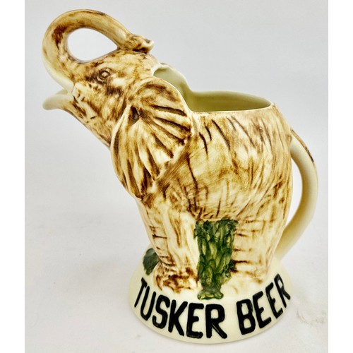 348 - TUSKER BEER WATER JUG. 9.2ins tall. Full figure multi coloured elephant - open mouth forming pouring... 