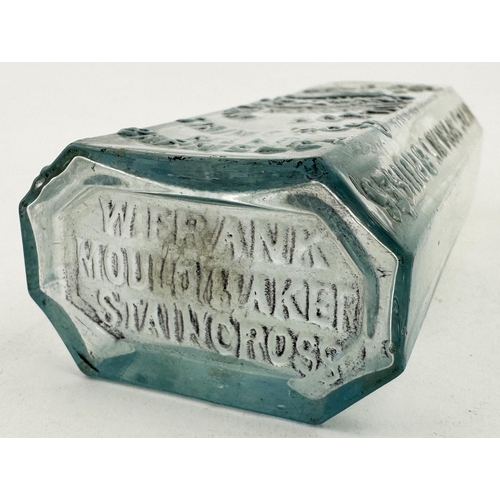 48 - HOLDENS TOMMY BOTTLE. 5.5ins, pale ice blue glass, rectangular body, chamfered corners. Embossed HOL... 