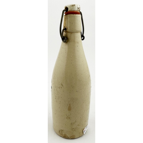 56 - G DISTEFANI LINLITHGOW GINGER BEER BOTTLE. 9ins tall, all white, ch., red printed swing stopper. Thr... 