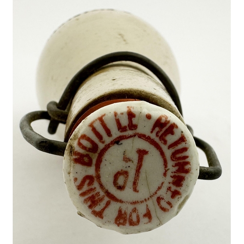 56 - G DISTEFANI LINLITHGOW GINGER BEER BOTTLE. 9ins tall, all white, ch., red printed swing stopper. Thr... 