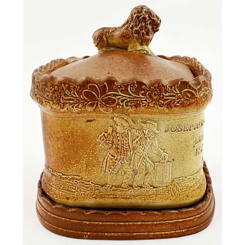 101 - BRAMPTON DATED TOBACCO JAR. 5.5ins tall. Square body, lion atop lid, separate base/ stand. Very vari... 