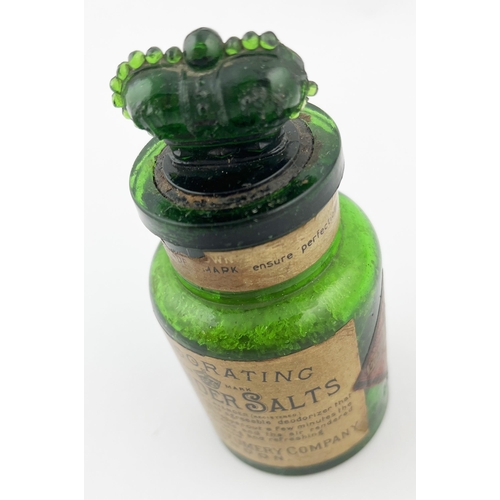 306 - CROWN PERFUMERY COMPANY LABELLED BOTTLE. 4ins tall. Emerald green glass, paper label, crown stopper,... 