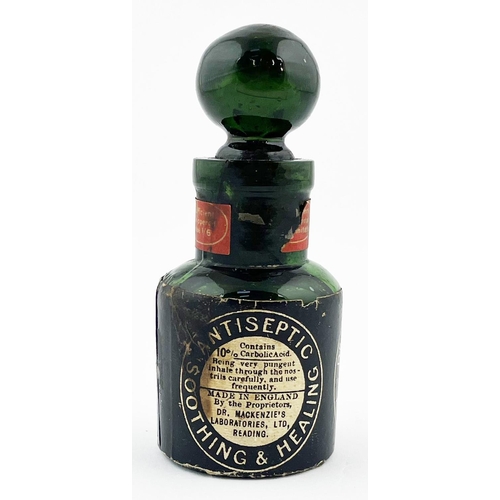 319 - DR MACKENZIES SMELLING BOTTLE. 4ins tall. Dark green glass, paper label, stopper & contents. Label d... 