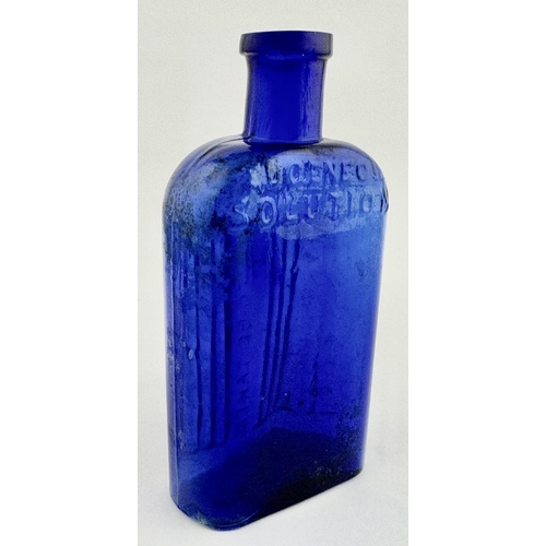 27 - UGENEOL POISON BOTTLE. 5.4ins tall. Cobalt blue, flattended rectangale shape with curved shoulders. ... 