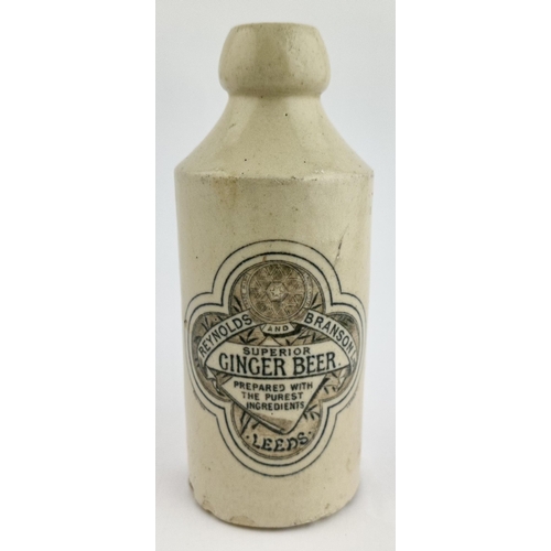 163 - REYNOLDS & BRANSON LEEDS GINGER BEER BOTTLE. 6.8ins tall. Std, all white, cork lip (hairline on left... 