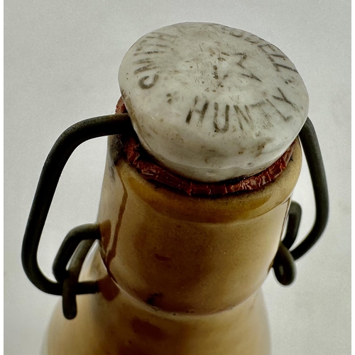 164 - SMITH & RIDDELL HUNTLEY GINGER BEER BOTTLE. 8.6ins tall. Ch., t.t., swing stopper - intact, worn. Wo... 