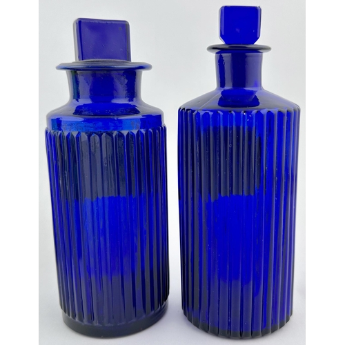 198 - PHARMACY LABEL UNDER GLASS SHOP ROUND DUO. Tallest 6.8ins. Cobalt blue glass, both vertically ribbed... 