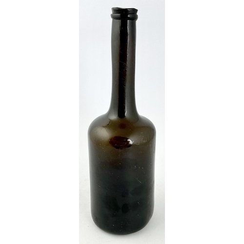 242 - LADIES LEG BLACK GLASS WINE BOTTLE. 11.1ins tall. Heavy, crude cylinder form, dense black glass, fea... 