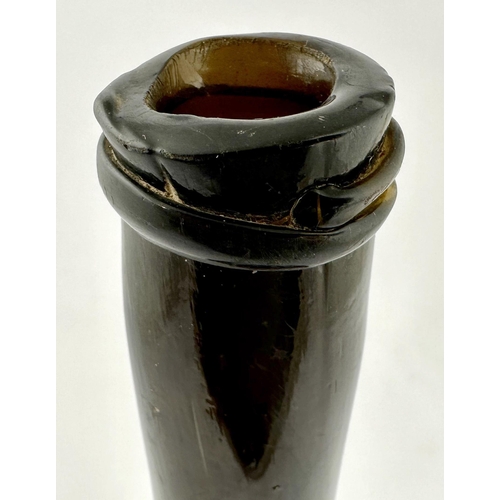 242 - LADIES LEG BLACK GLASS WINE BOTTLE. 11.1ins tall. Heavy, crude cylinder form, dense black glass, fea... 